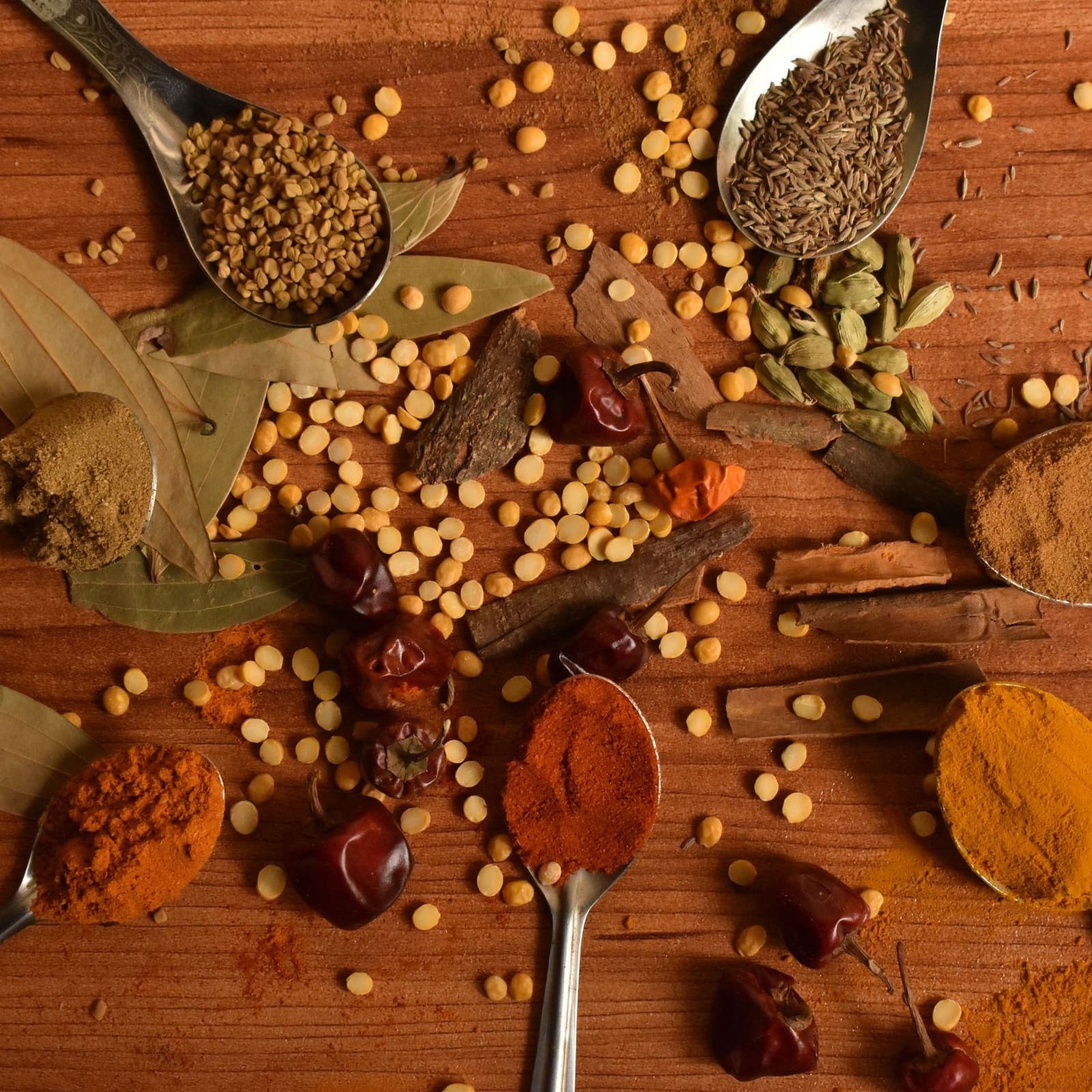 Turmeric, chilli, cardamom and lentils on a wooden table